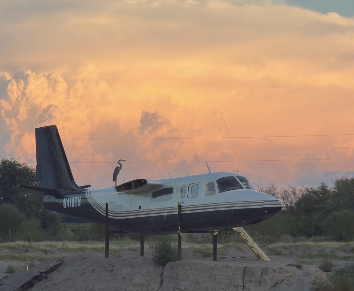 An unusual ranch landmark beneath a colorful sunset