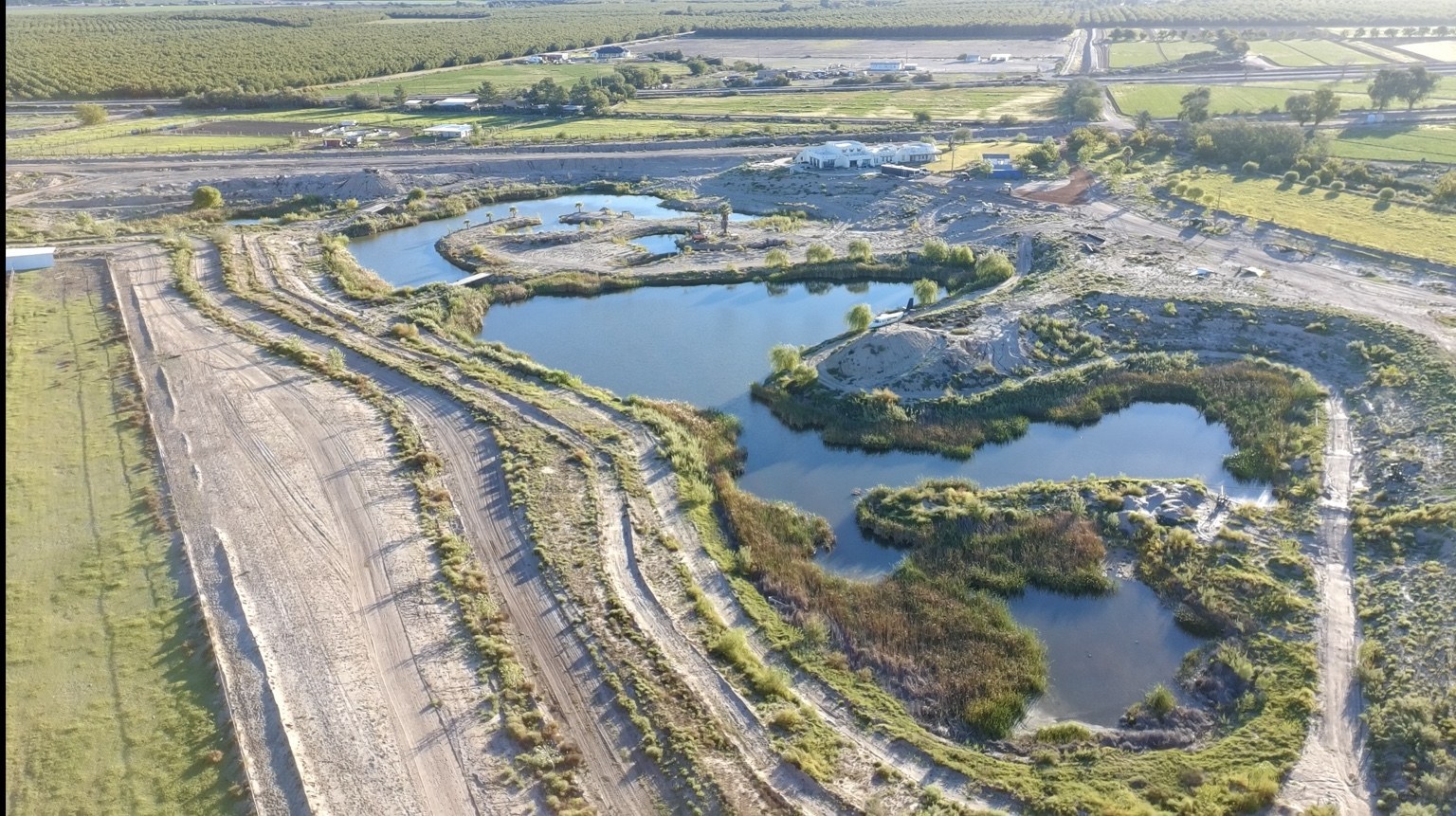 Aerial view of the private lake, islands, crossings, and surrounding trails at Harvey Lake Ranch